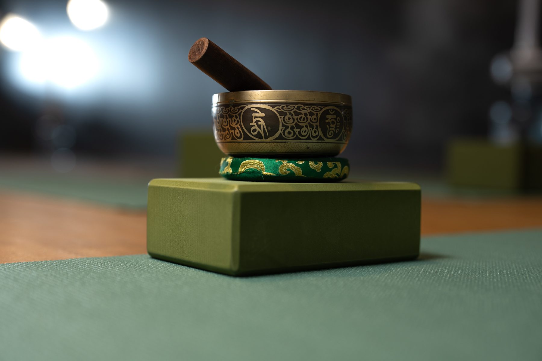 Singing bowl on an olive block