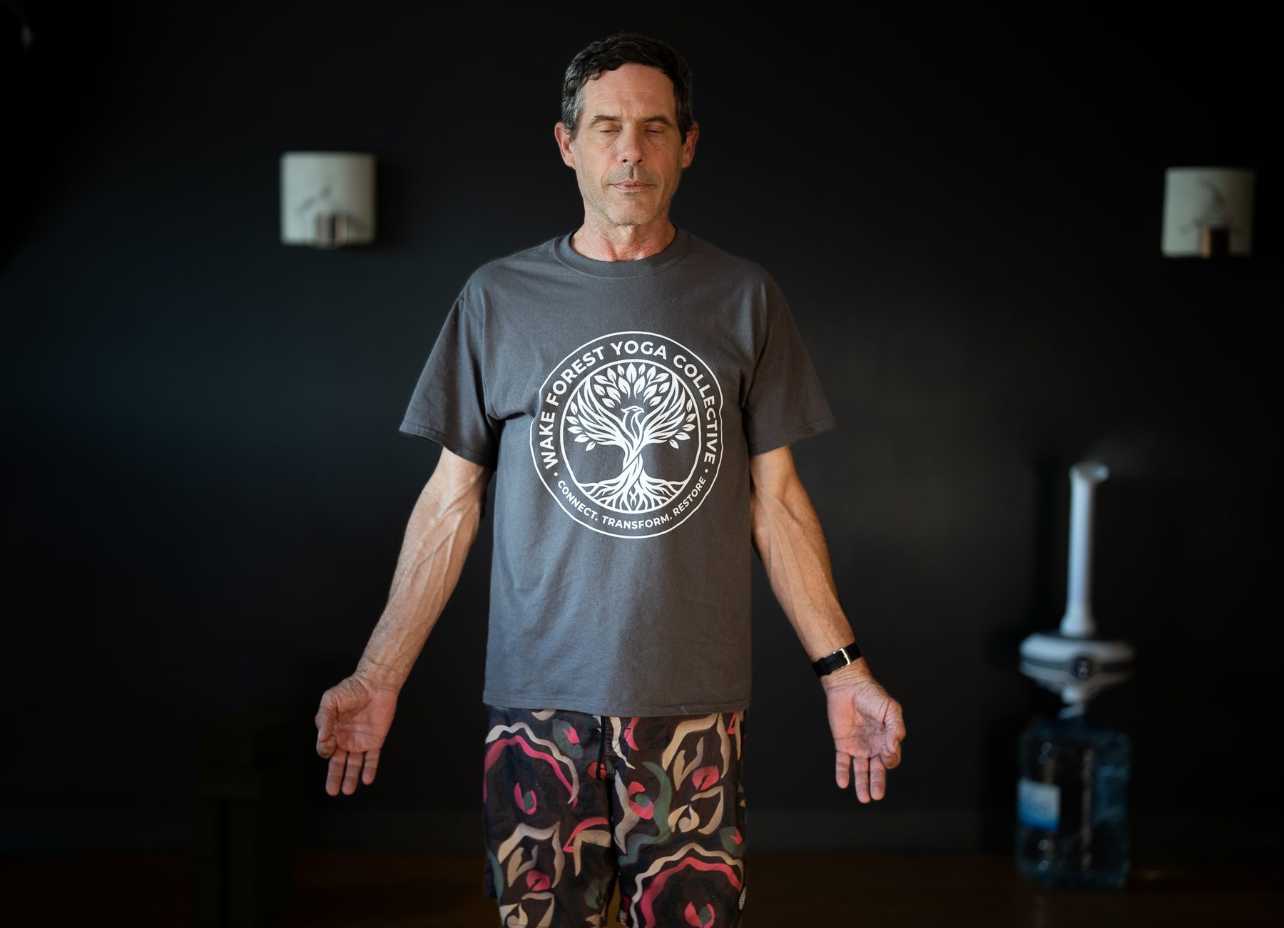 A teacher standing in stillness at Wake Forest Yoga Collective