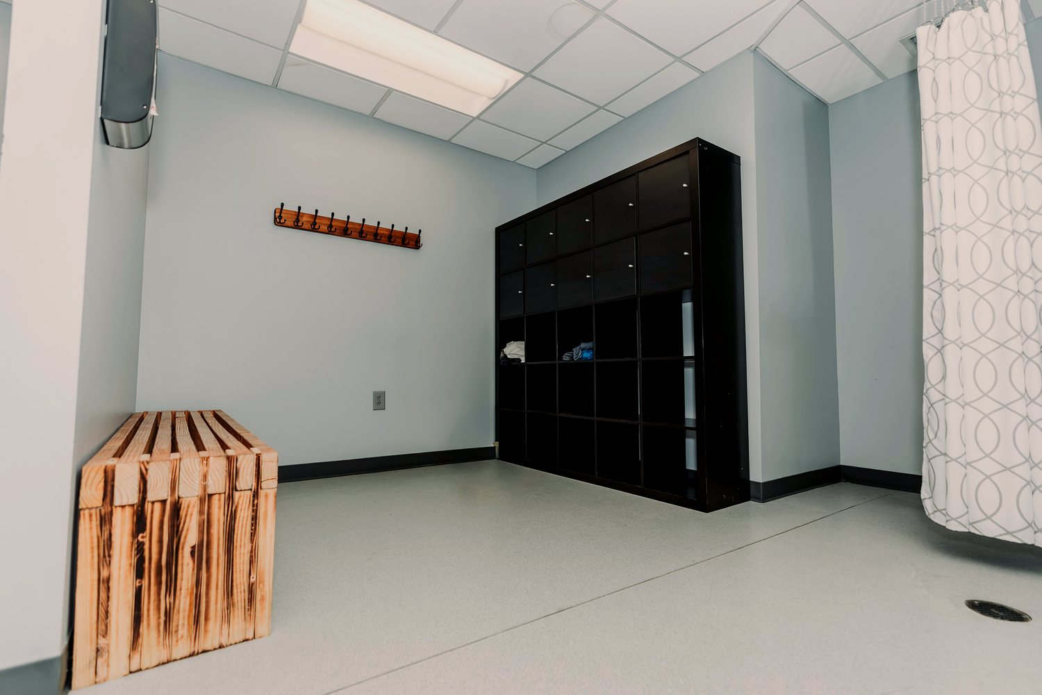 The locker room with cubbies and changing bench