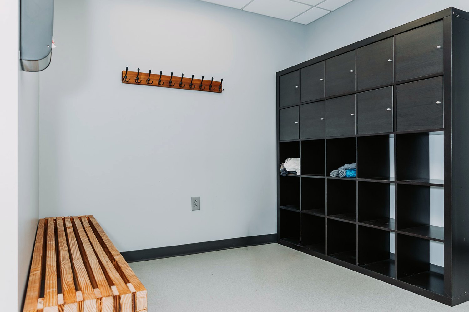 The locker room with cubbies and a changing bench