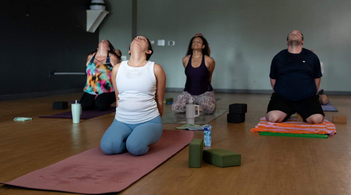 A group of students kneeling together in an open-hearted moment