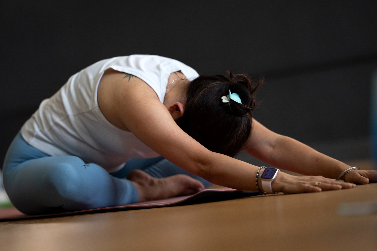 A student folding deeply in a yin posture